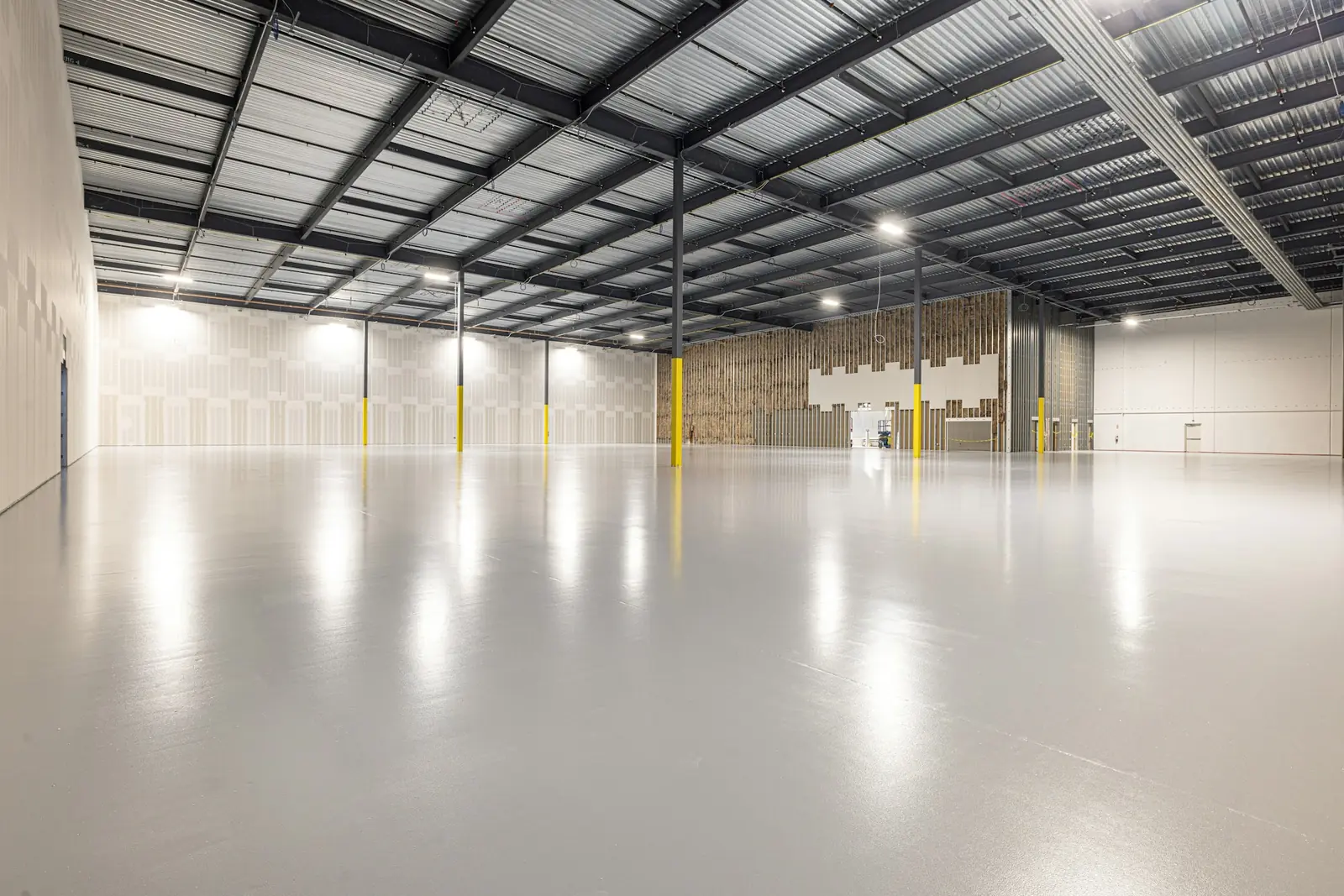 Finished light gray epoxy floor in an empty warehouse
